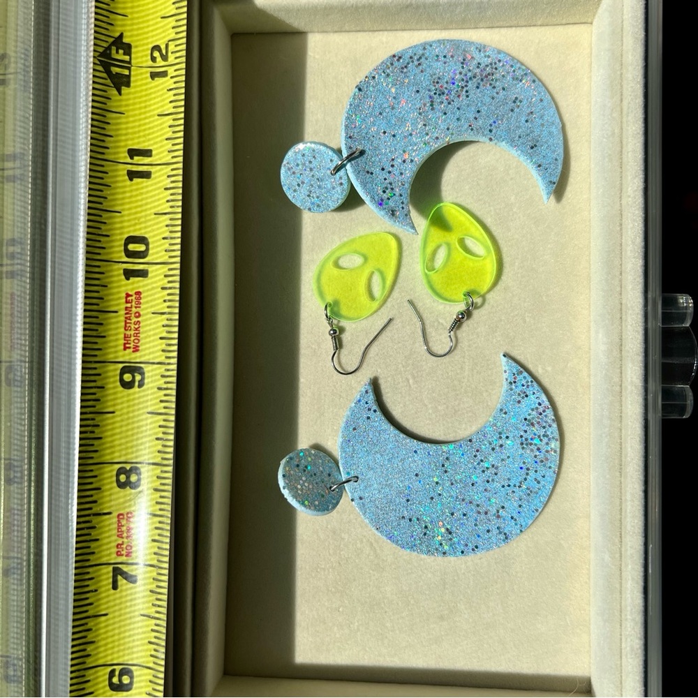 Alien and moon earrings.